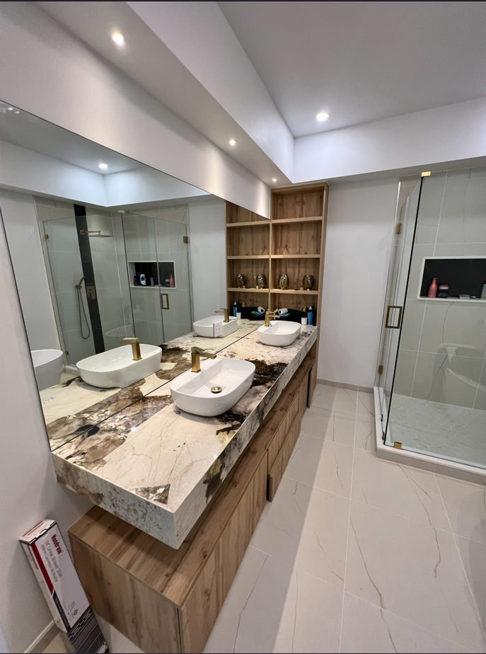 Finished bathroom with new vanity, quartzite slab, and vessel sinks after the repipe