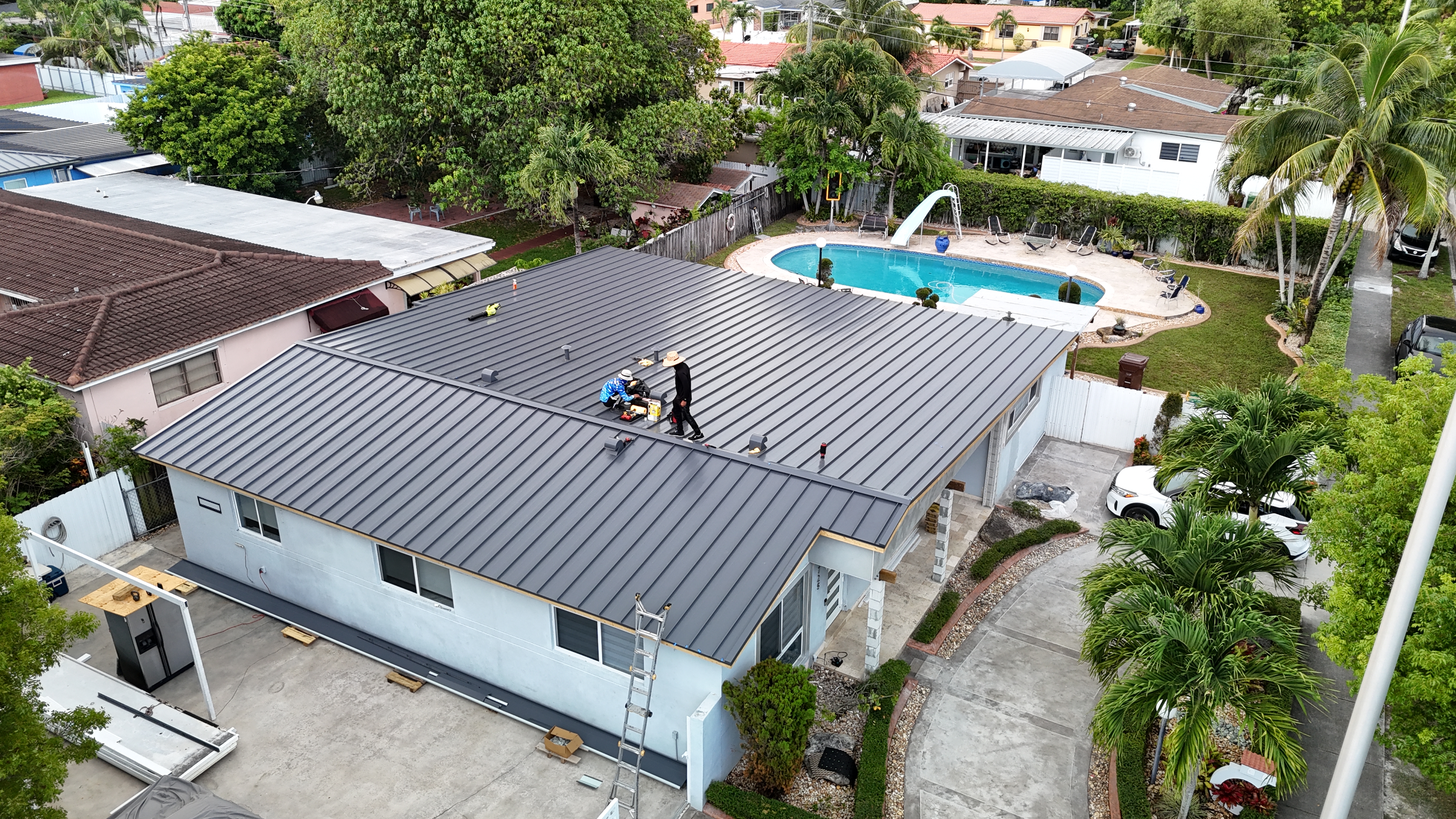Aerial view of the finished standing-seam metal roof on the same house