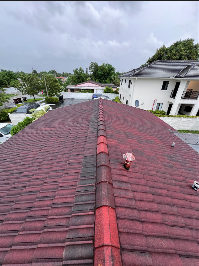 Worn red tile roof before replacement in Miami-Dade